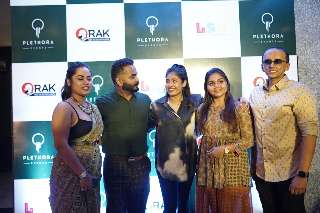 Plethora Events guests photographed at the branded launch backdrop