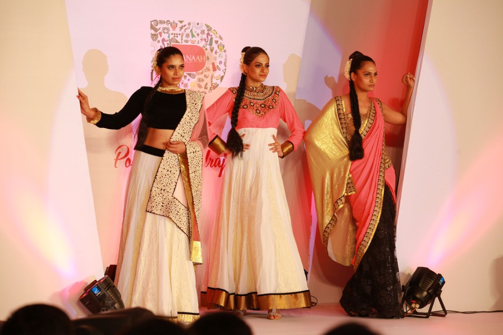 Three models presenting looks in front of the Pranaah identity backdrop
